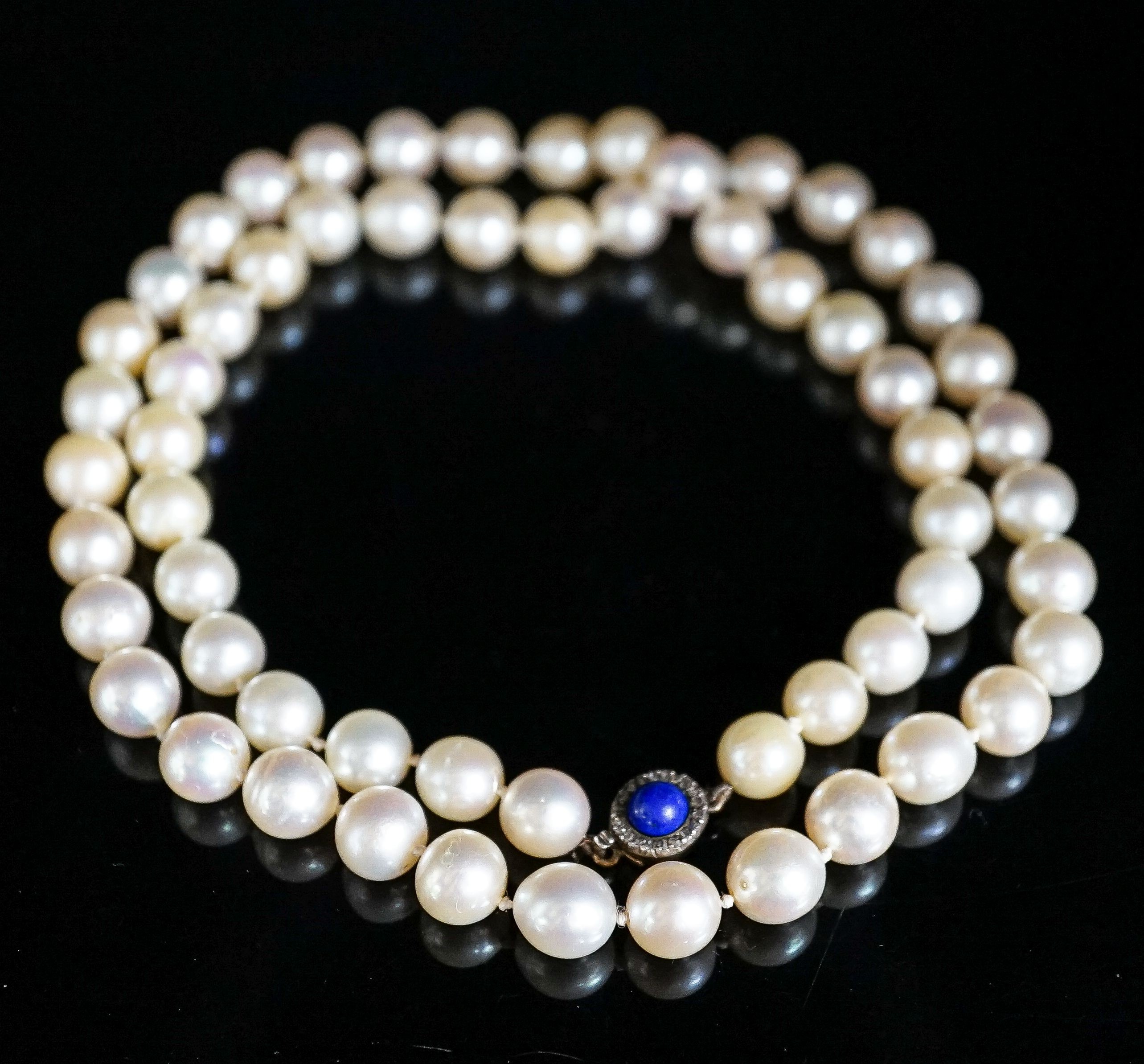 A single strand cultured pearl necklace, with yellow metal, lapis lazuli and diamond set clasp, 63cm, gross weight 67.1 grams.